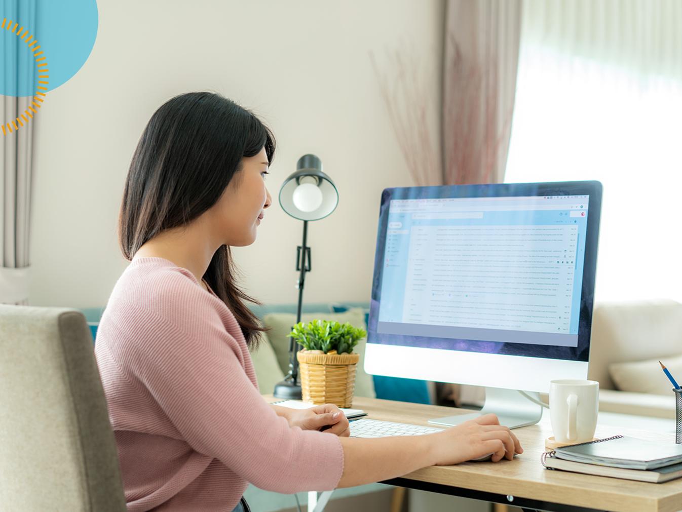 woman working on data entry at a desktop computer